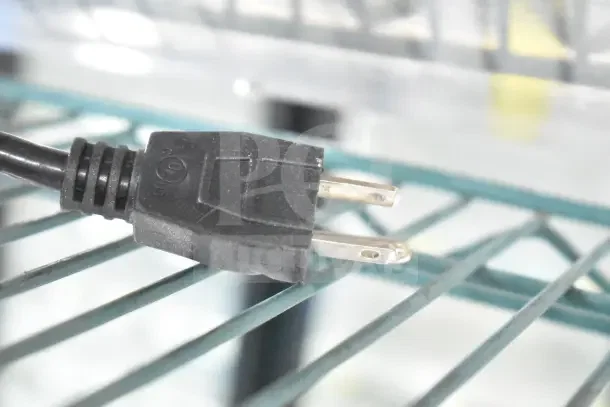 Black plug of a ServIt 423HSW2030 heated shelf warmer, 120V, 1 Phase, on a metal rack.