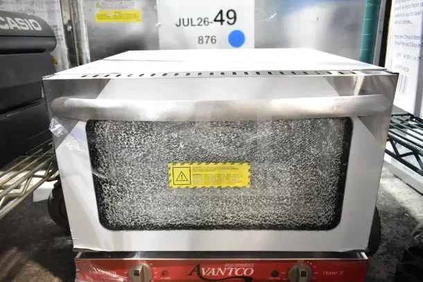 Brand new Avantco 177CO14 countertop convection oven, 0.8 cu. ft., scratch and dent, with visible glass damage. 120 volts, 1 phase.
