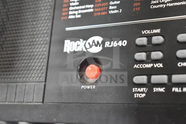 Rock Jam RJ640 keyboard close-up showing power button and control panel.