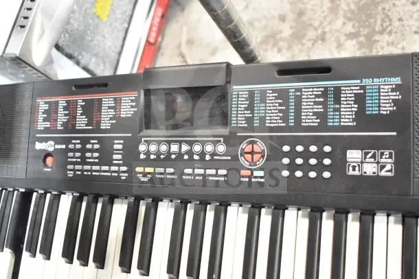 Rock Jam RJ640 keyboard with 350 rhythms, multiple buttons for tone control, and teaching functions, in good condition.