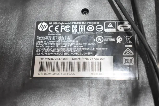 HP USB Keyboard Model Kb57211 label, indicating model, certifications, and manufacturing details. Made by Primax Electronics.