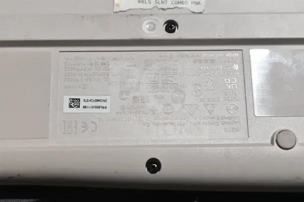 Close-up of a Logitech K270 keyboard label showing model details, certification marks, and serial number in fair condition.