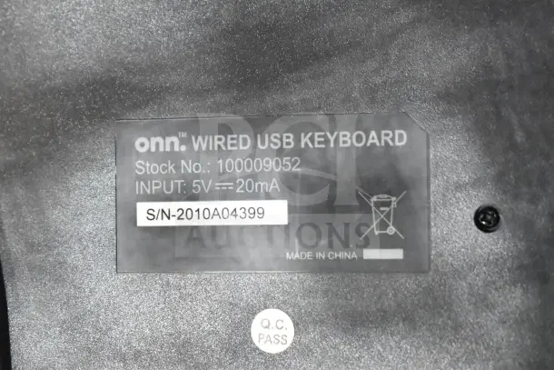 Label on Onn wired USB keyboard showing stock number 100009052, input 5V, made in China, and QC pass mark.