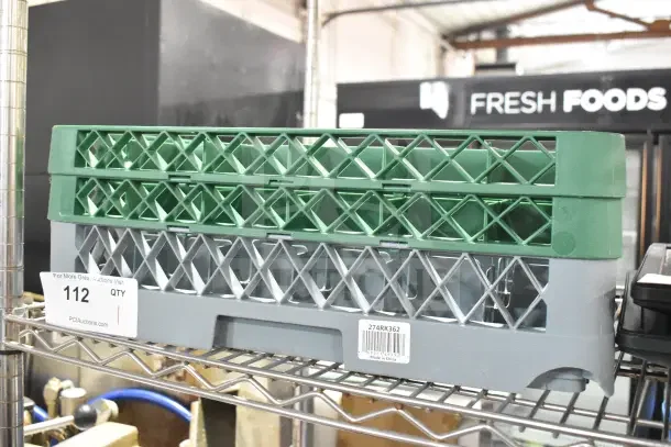 Brand new Noble Warewashing 36-compartment gray glass rack with two green extenders, model 274RK362, on metal shelf.