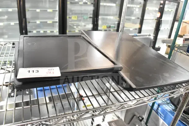 Three Dell monitors, including E1715Sc and E1715S models, on a shelf. Moderate wear, auction tag "113 QTY x3".