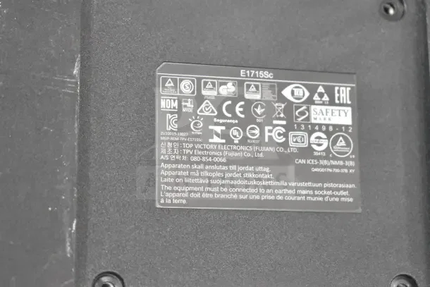 Close-up label of Dell E1715Sc monitor, showing compliance symbols, model number, and manufacturer details.