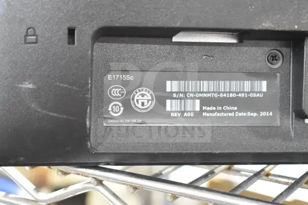 Close-up of a Dell E1715Sc monitor label showing model details, serial number, and manufacture date, September 2014.