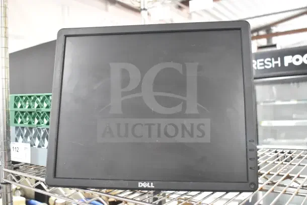 Dell E1715Sc monitor on a metal shelf, black frame, flat screen, visible Dell logo. Used condition.
