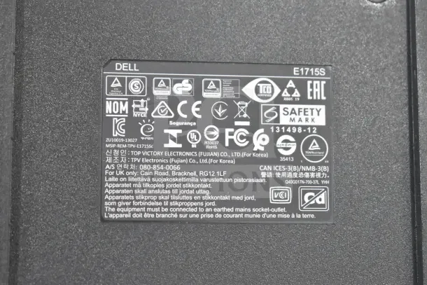Close-up of Dell E1715S monitor label showing model number, certifications, and manufacturer details from TPV Electronics.