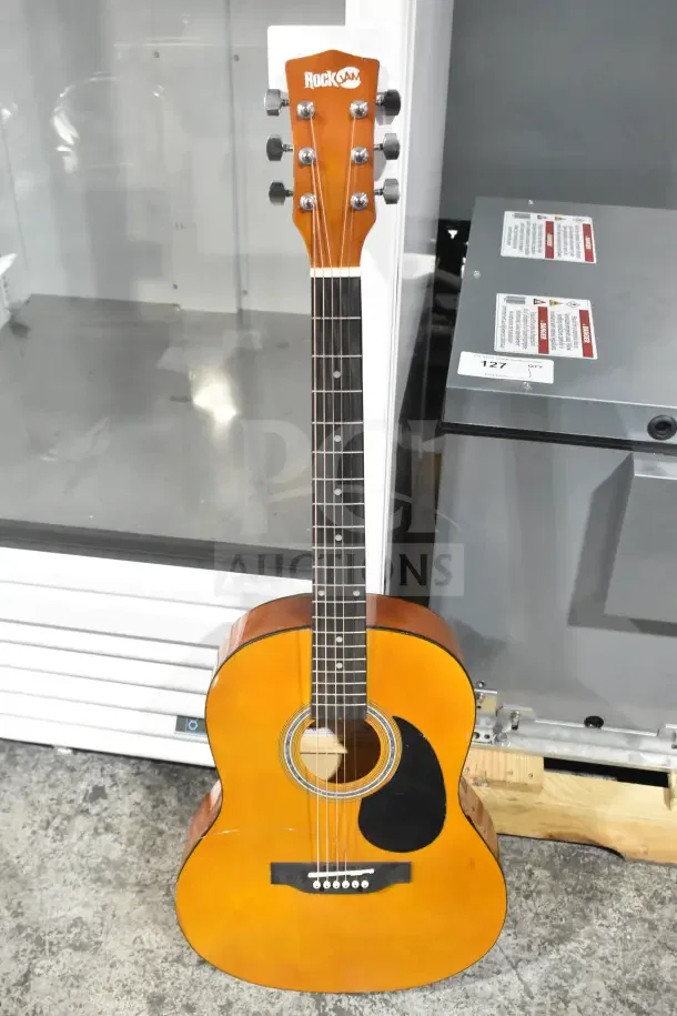Rock Jam acoustic guitar, natural wood finish, excellent condition, branded headstock, visible professional setup.