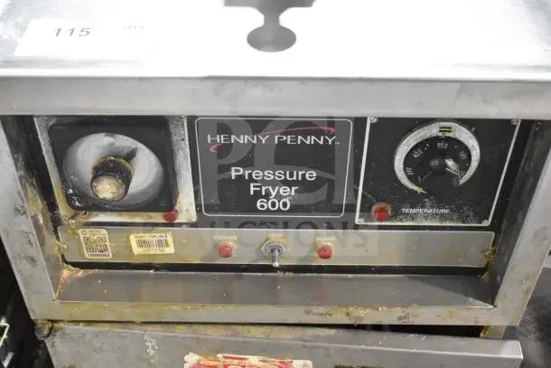 Henny Penny 600 commercial pressure fryer, natural gas, floor style on casters, 80,000 BTU, wear visible on controls.