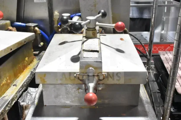 Henny Penny 600 floor-style natural gas pressure fryer with 80,000 BTU capacity, commercial casters, visible wear.