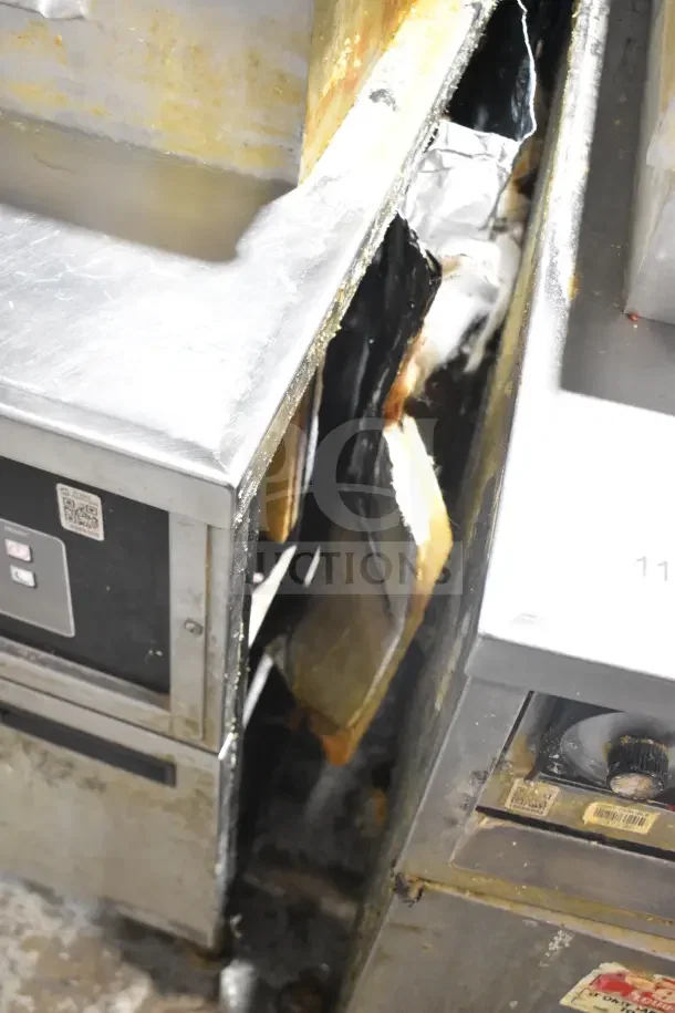 Henny Penny 600 pressure fryer, floor style, natural gas, 80,000 BTU, on casters, used condition, visible wear.