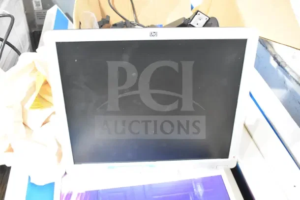 HP LE1711 computer monitor with 17-inch screen, black bezel. Shows signs of wear. No visible tags or labels.