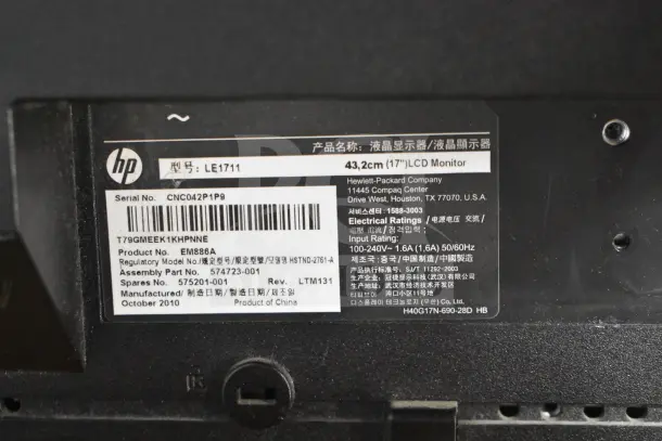 HP LE1711 Computer Monitor label showing serial number CNC042P1P9, model EM888A, and October 2010 manufacture date.