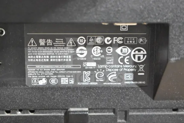 HP LE1711 computer monitor back panel, showing safety labels, compliance logos, and warnings.