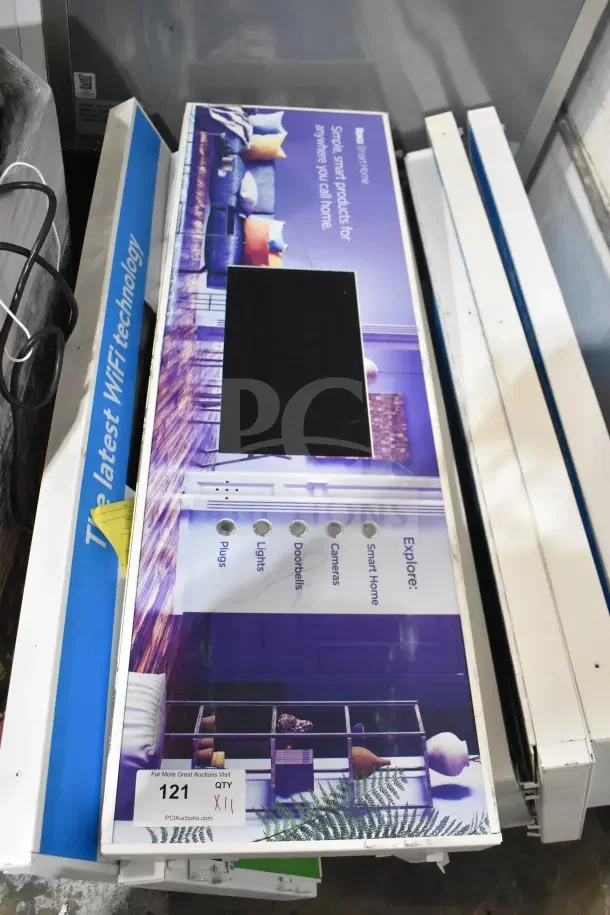 Stack of 11 Netgear monitors featuring latest WiFi technology in unopened packaging, auction label indicating lot quantity.