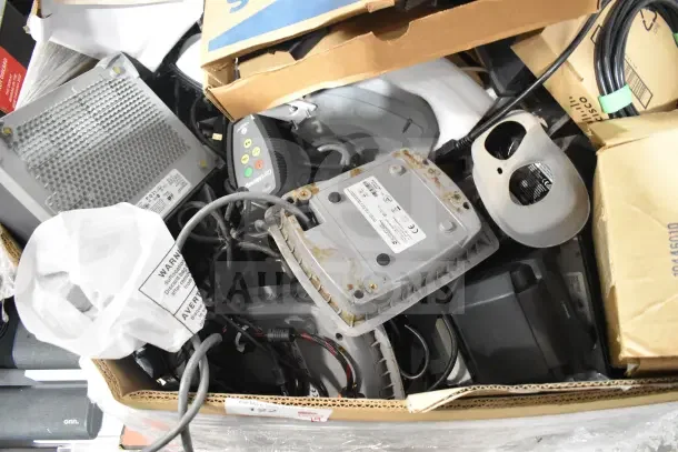 Pallet lot with various items, including a Sensormatic ZBSMPROE and a computer keyboard, mixed condition.
