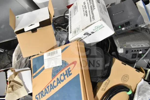 Pallet lot containing various items including Sensormatic ZBSMPROE, computer keyboard, Stratacache box, and cables.