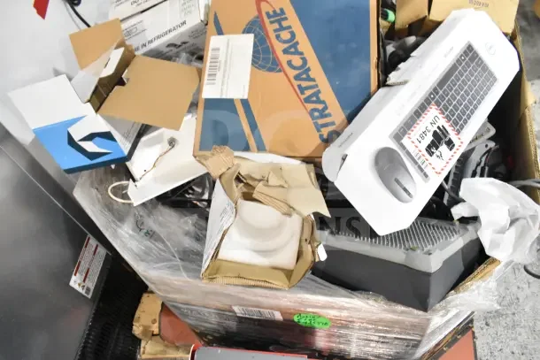 Pallet lot with computer keyboard, Sensormatic ZBSMPROE, boxes, and assorted items. Various conditions and packaging.