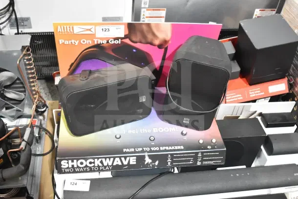 Altec Lansing store display featuring two speakers, labeled "Party On The Go." Includes "Shockwave" branding.