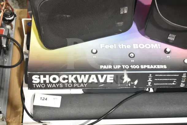 Store display with two Altec Lansing speakers on a Shockwave-themed base, featuring marketing text and condition wear.