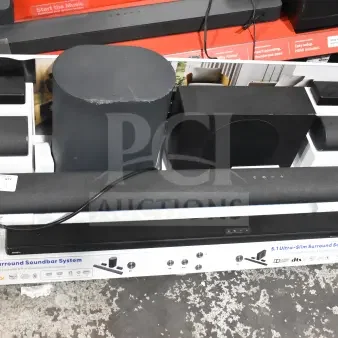 Store display featuring various Onn sound bars and speakers, showcasing 5.1.2 surround sound systems with wireless subwoofer. Pricing tags visible.