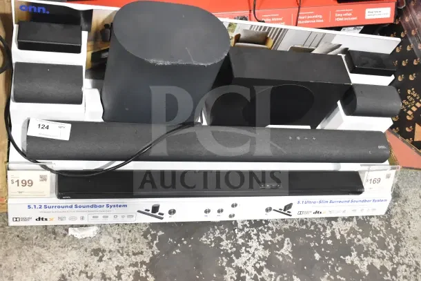 Store display of Onn sound bars and speakers, featuring 5.1.2 surround soundbar system. Tags indicate $199 and $169.