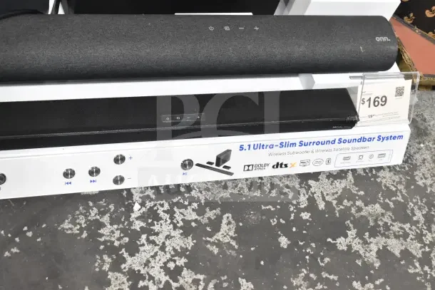 Store display featuring Onn sound bars and speakers with Dolby Atmos and 5.1 ultra-slim surround system. Pricing label shows $169.