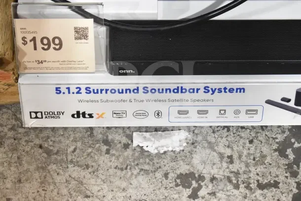 Onn store display featuring a 5.1.2 Surround Soundbar System with wireless subwoofer, Dolby Atmos, and multiple input options. Price tag shows $199.
