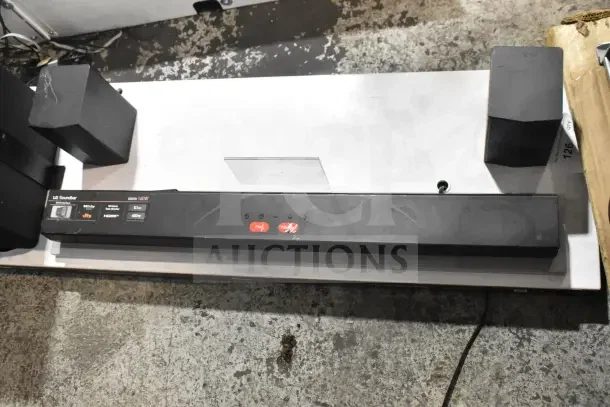LG sound bar with two speakers on display board, featuring HDMI, DTS, optical input, and 4.0v capabilities.
