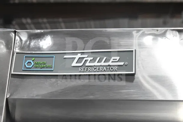 True T-35-HC commercial cooler label, featuring natural refrigerant logo. Stainless steel surface visible.