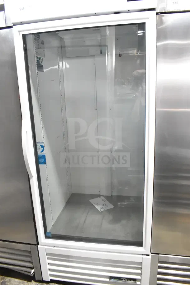 2021 True TSCI-600R-G-PH commercial single door cooler. Glass door, white interior, excellent condition, 115V, 1 phase.