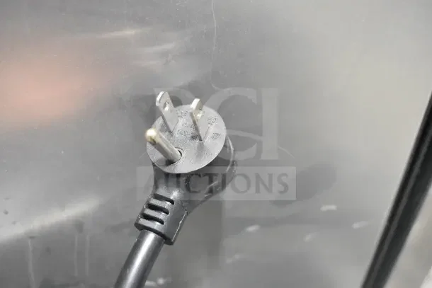 2021 True TSCI-600R-G-PH cooler plug, 115 volts, 1 phase, Model T-35, black power cord against metal surface.