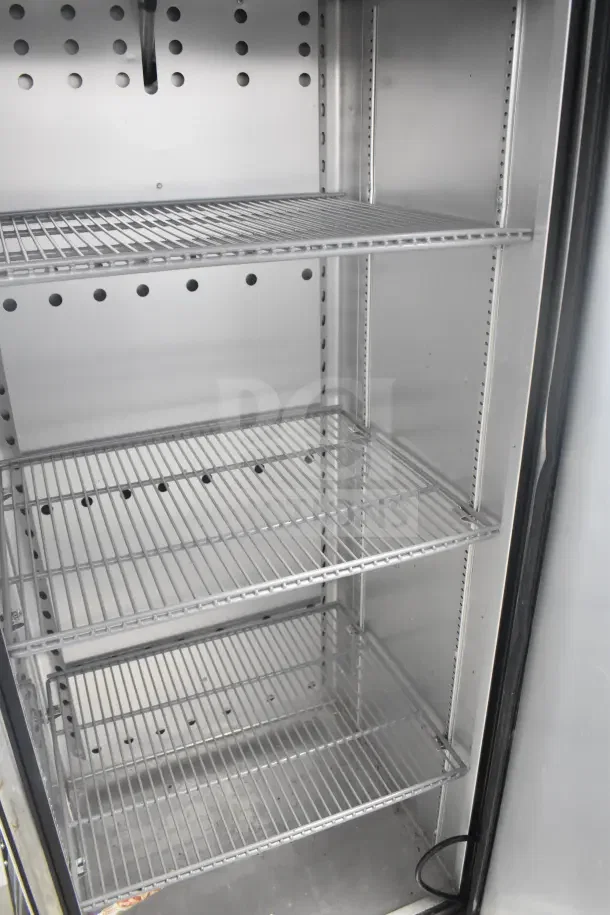2018 True T-19F-HC commercial single door freezer, three shelves, interior view. Some damaged casters noted.