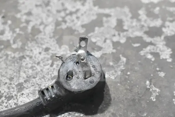 Frayed electrical plug of 2018 True T-19F-HC reach-in freezer, indicating potential wiring damage.