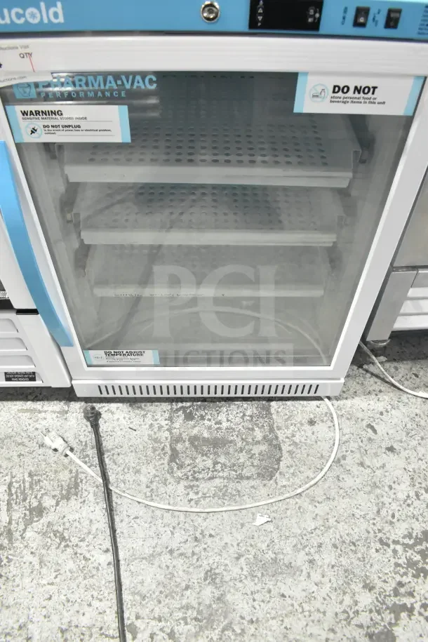 Accucold ARG6PV Mini Cooler Merchandiser, 110V, 1 Phase, glass door, shelves visible, caution labels present.