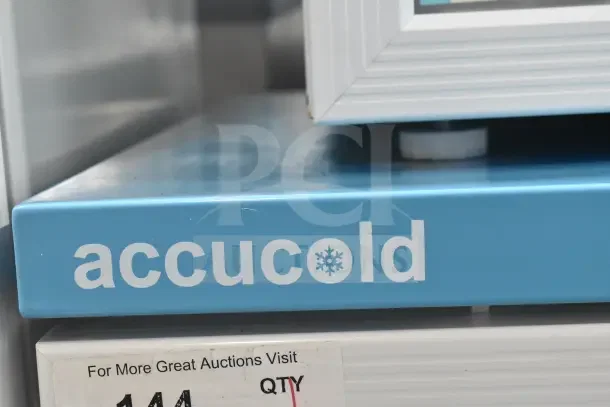 Accucold ARG6PV Mini Cooler Merchandiser, blue branding, model ARG6PV, 110 volts, 1 phase, label with auction info.