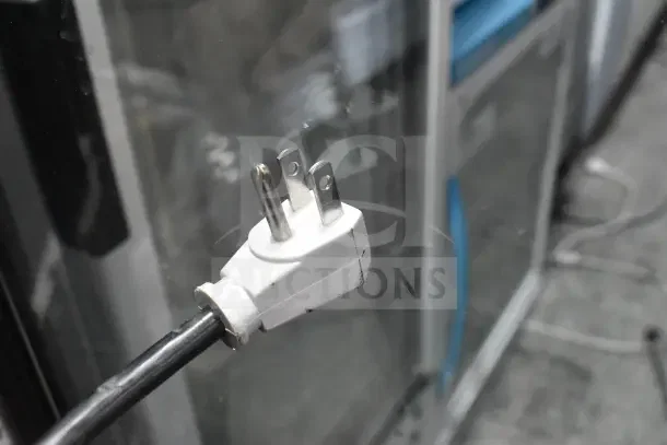 True GDM-12-HC-LD cooler power cord plug, 115V, 1 phase. Visible connector details, glass door reflection.