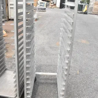 Commercial pan transport rack on durable casters, multiple shelves, silver metal, used condition, label "149 HGT QTY".
