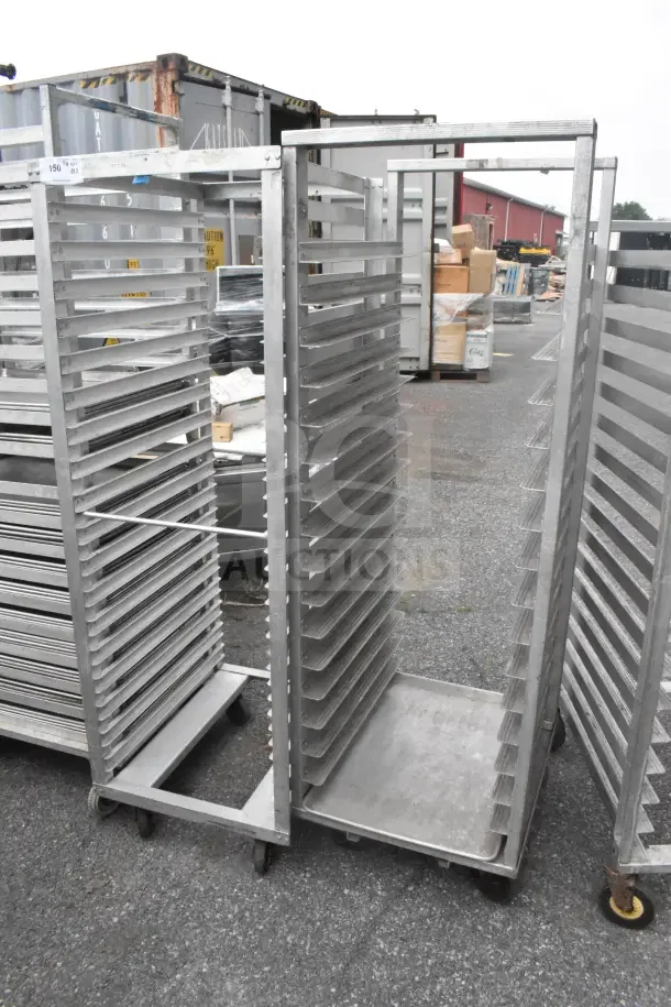 2 commercial pan transport racks on casters in good condition, multiple shelves, ideal for bakery or food service use.
