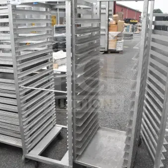 2 commercial pan transport racks on casters in good condition, multiple shelves, ideal for bakery or food service use.