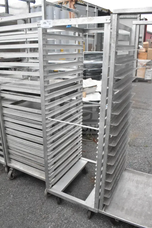 2 commercial pan transport racks on casters, metal construction, used condition. Holds multiple pans, ideal for kitchens.