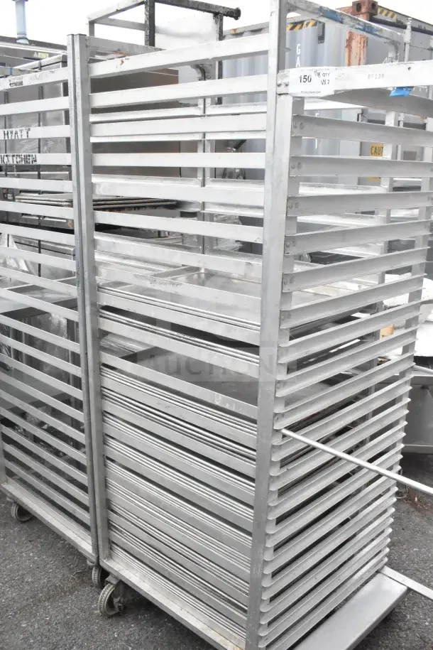 2 commercial pan transport racks on casters with 40 baking pans. Durable metal construction, ideal for kitchen use.