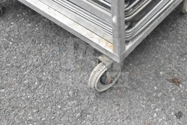2 commercial pan transport racks on casters, used, each with 40 baking pans included.