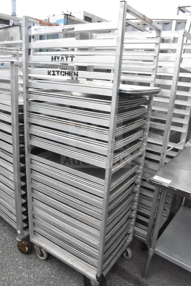 Commercial pan transport rack with 56 baking pans, labeled "Hyatt Kitchen," in good condition, metal construction.