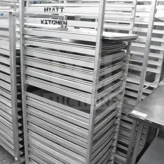 Commercial pan transport rack with 56 baking pans, labeled "Hyatt Kitchen," in good condition, metal construction.