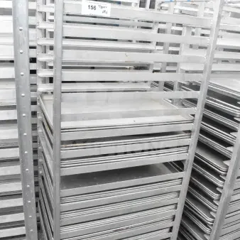 2 commercial pan transport racks with 44 baking pans in good condition. Includes visible tag with auction details.