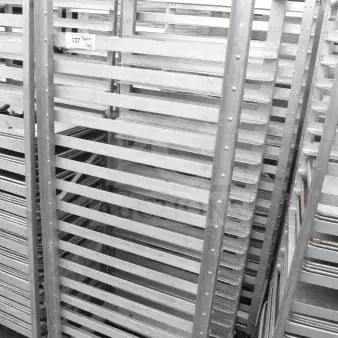Commercial pan transport rack, sturdy metal, multiple slots for pans, on casters for mobility. Auction includes two racks.