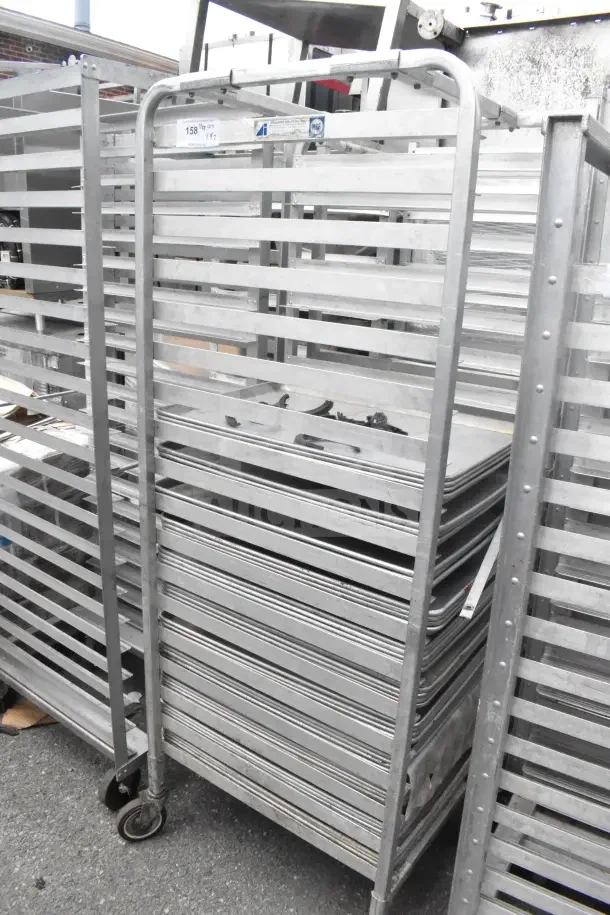 Two commercial pan transport racks with wheels, containing 68 baking pans, shown in used condition with visible labels.